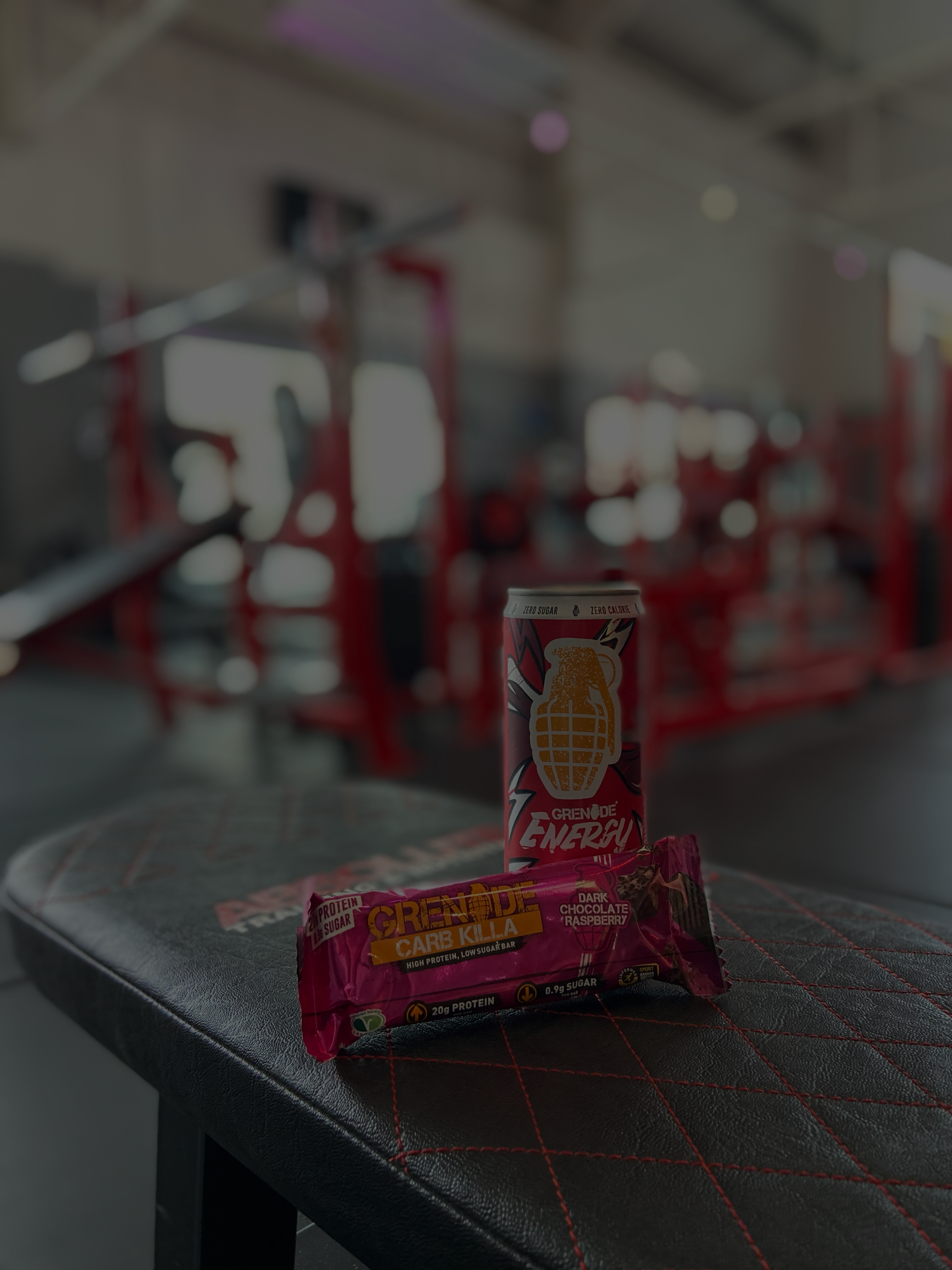 An energy drink and protein bar in the gym